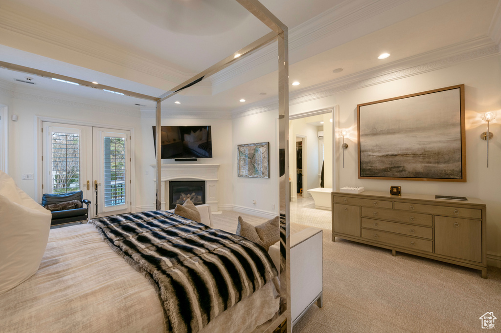 Bedroom featuring french doors, access to exterior, light carpet, and crown molding