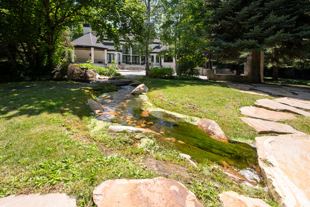 View of grassy yard featuring a garden pond