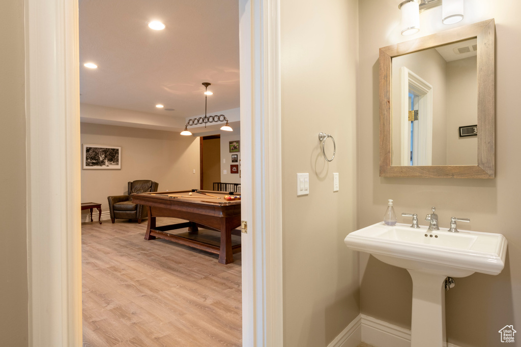 Bathroom with hardwood / wood-style flooring and billiards