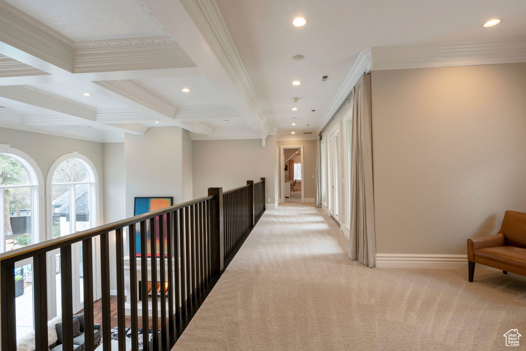 Hall with coffered ceiling, light carpet, beam ceiling, and crown molding