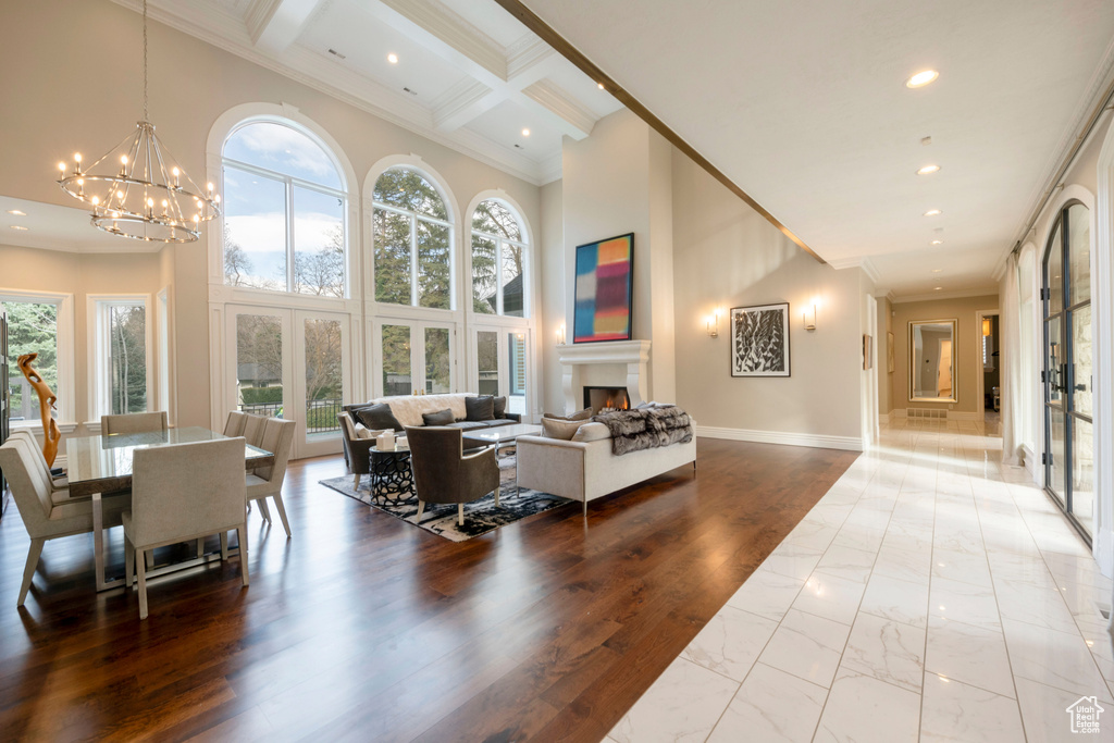 Interior space featuring coffered ceiling, a chandelier, hardwood / wood-style flooring, and french doors
