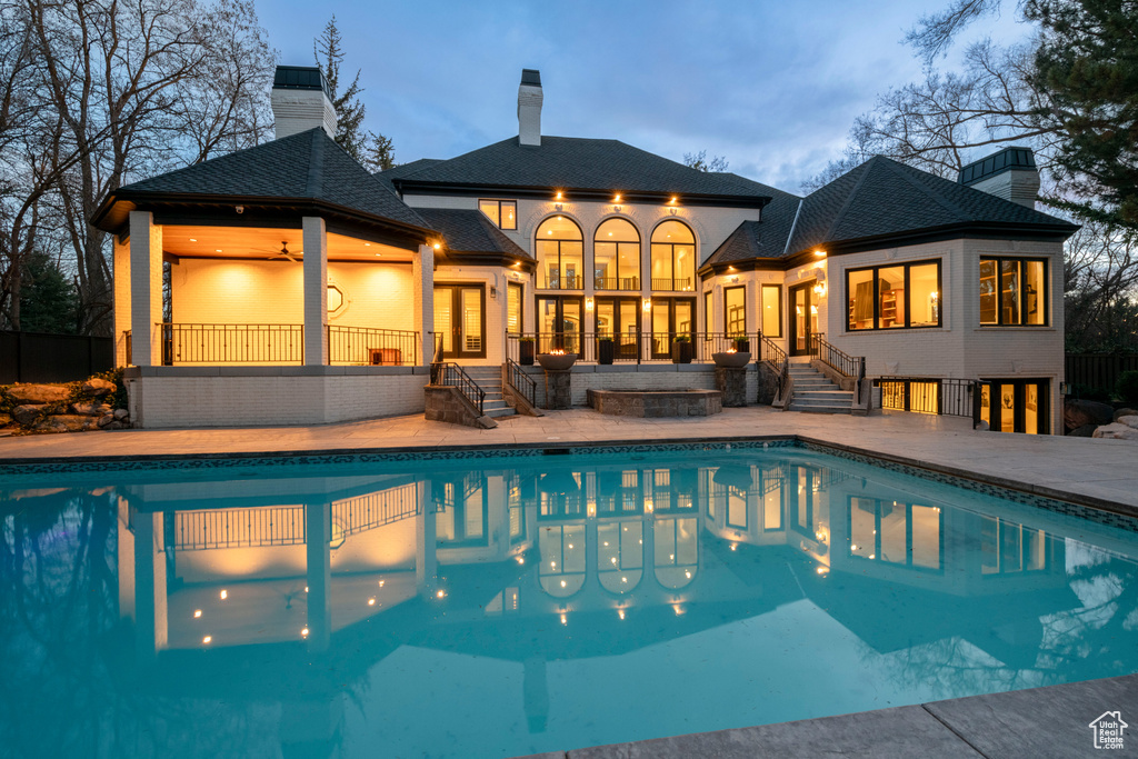 View of swimming pool featuring a patio, a jacuzzi, and an outdoor fire pit