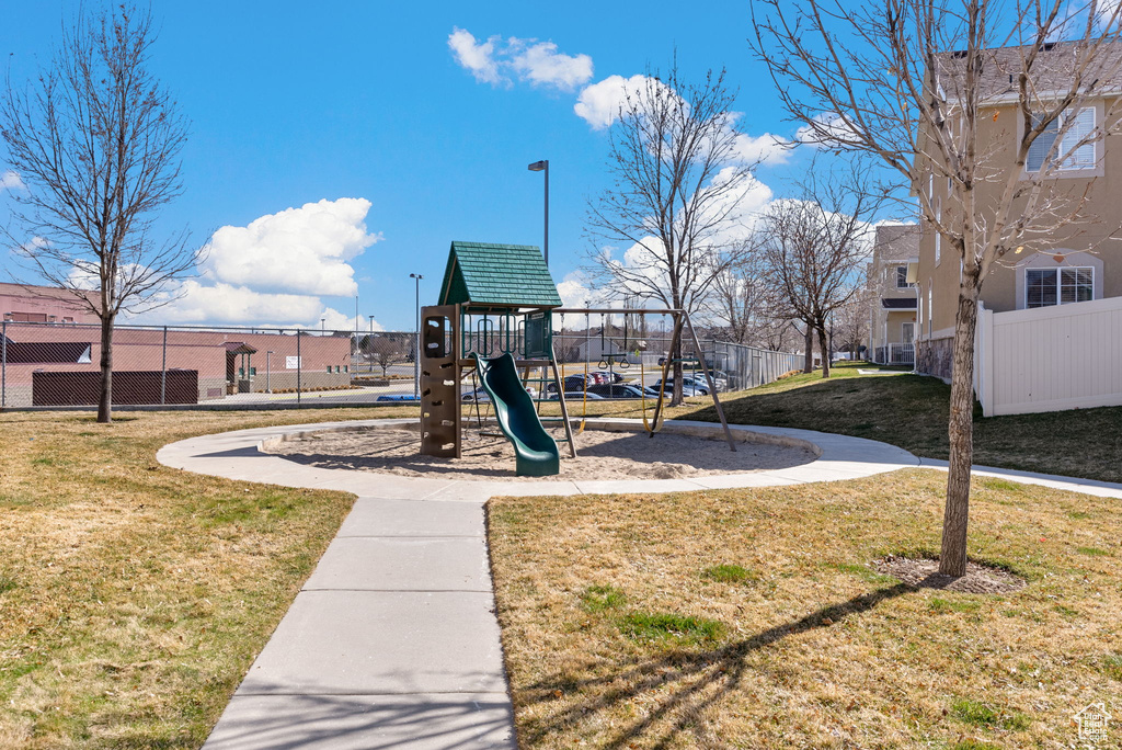 Surrounding community with a yard and a playground