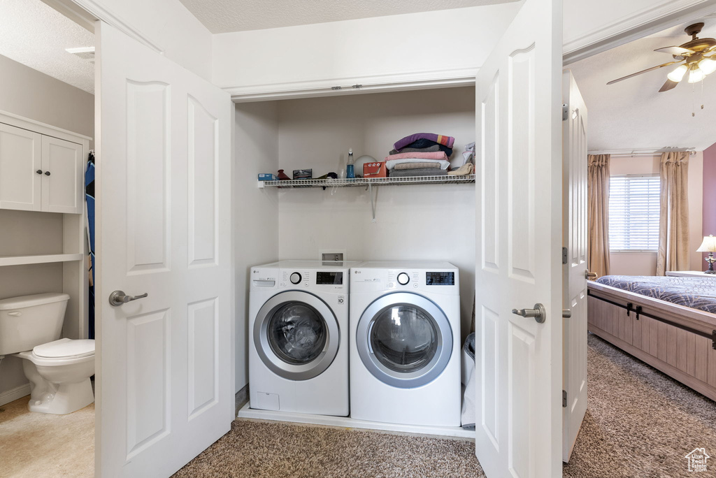 Laundry area featuring light colored carpet, hookup for a washing machine, ceiling fan, and washer and dryer