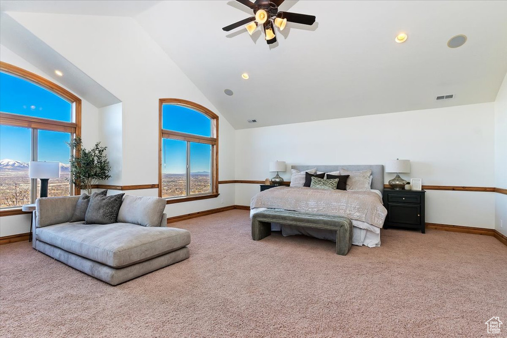 Bedroom with light colored carpet, high vaulted ceiling, and ceiling fan