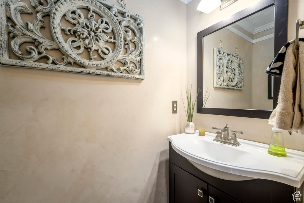 Bathroom with vanity and ornamental molding
