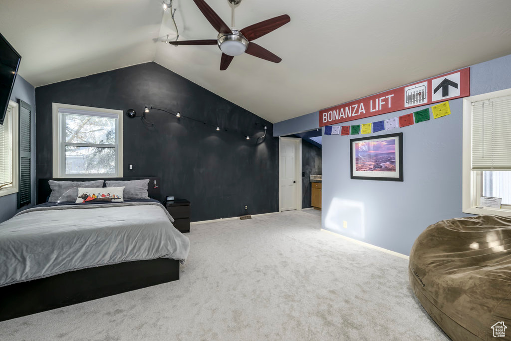 Bedroom featuring lofted ceiling, carpet floors, a closet, and ceiling fan