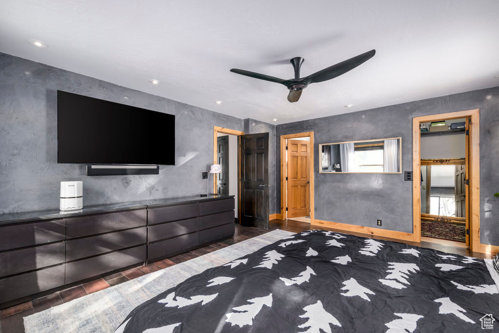 Unfurnished bedroom with ceiling fan and dark hardwood / wood-style floors