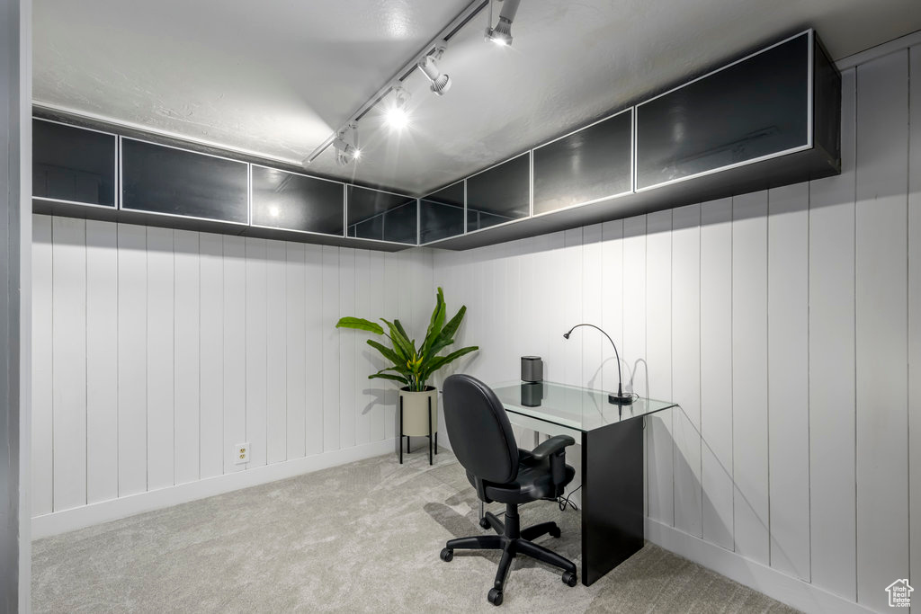 Home office featuring light carpet and track lighting