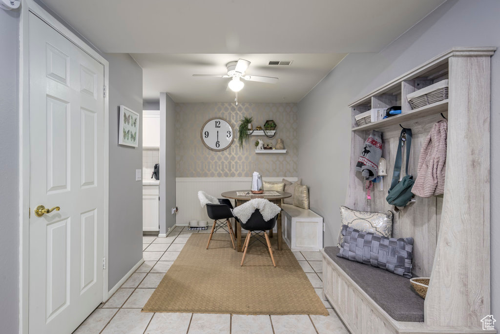 Mudroom with light tile floors and ceiling fan
