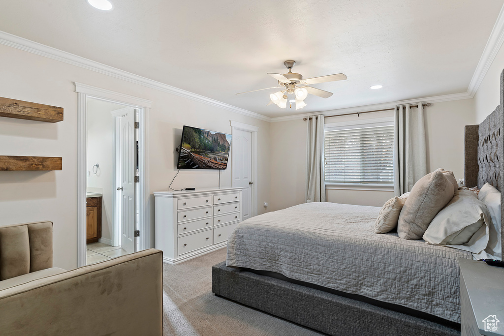 Bedroom with light colored carpet, ornamental molding, and ceiling fan