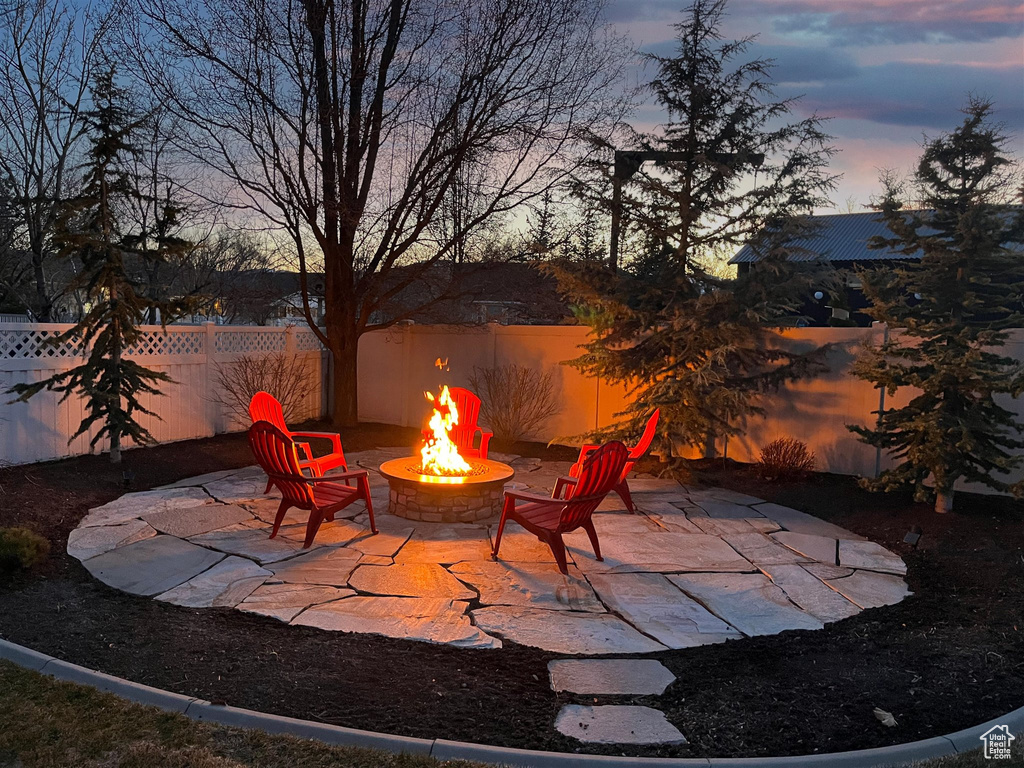 Patio terrace at dusk with a fire pit