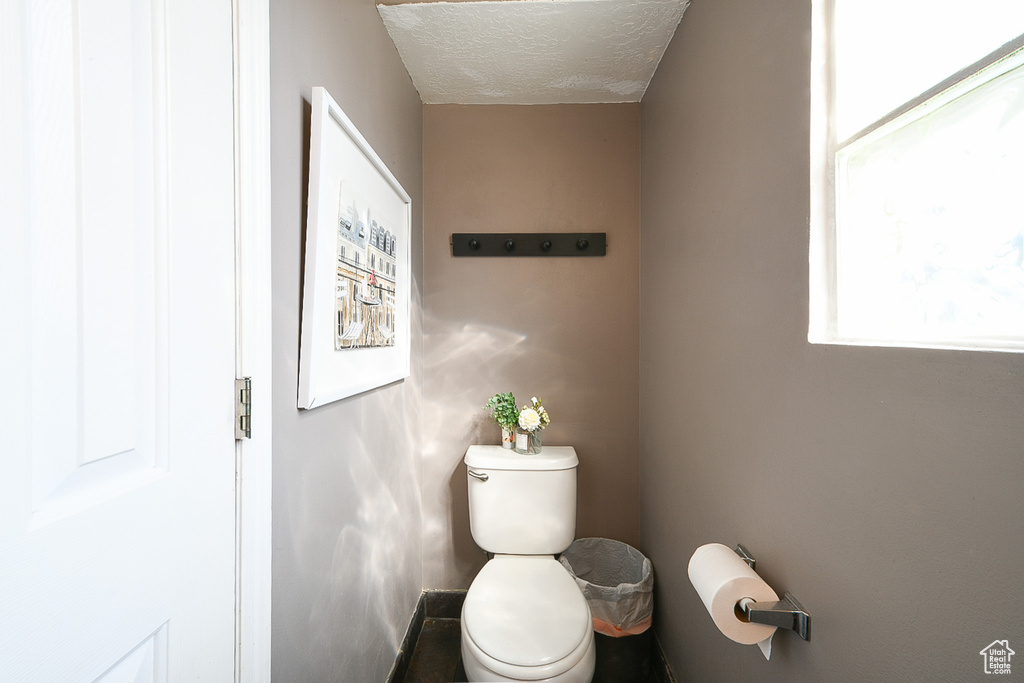 Bathroom featuring toilet and a textured ceiling