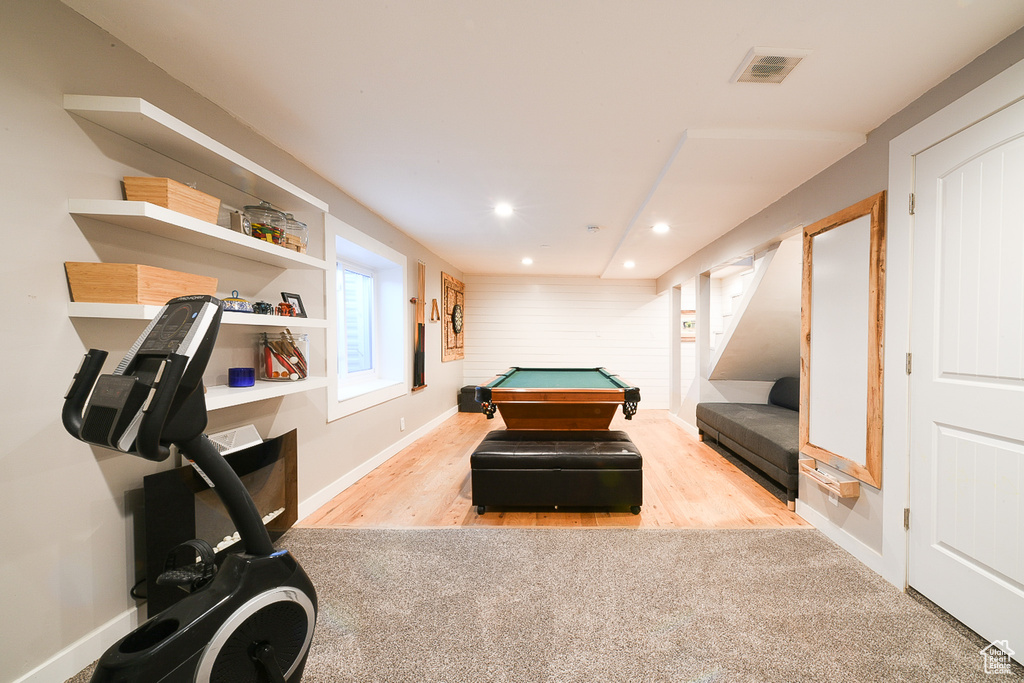 Bedroom with light hardwood / wood-style flooring and pool table