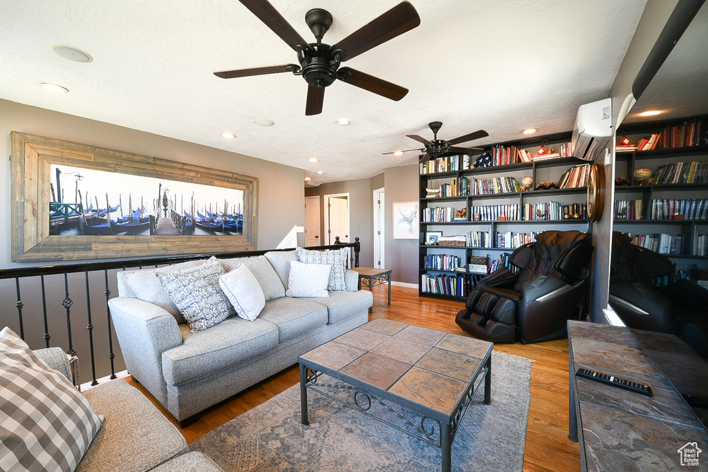 Living room featuring hardwood / wood-style flooring and ceiling fan