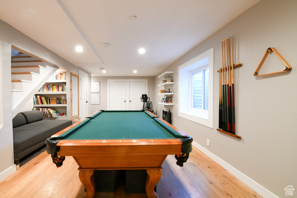 Rec room with light wood-type flooring, built in shelves, and pool table