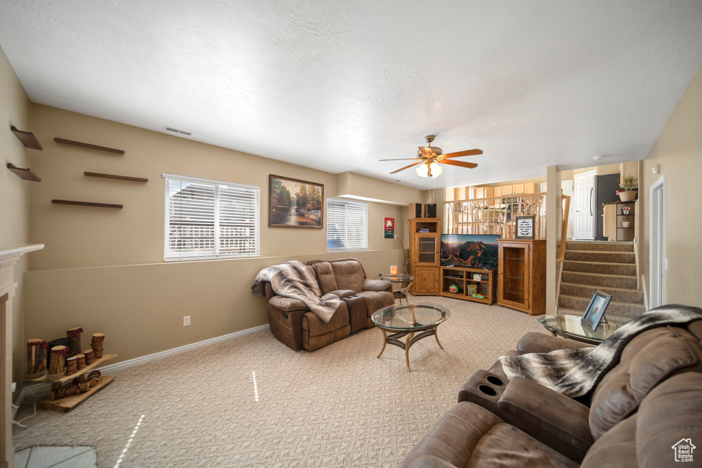 Living room with light carpet and ceiling fan