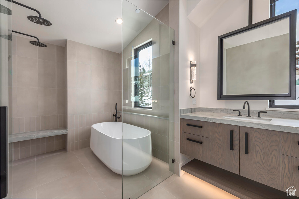 Bathroom featuring vanity, tile walls, and tile floors