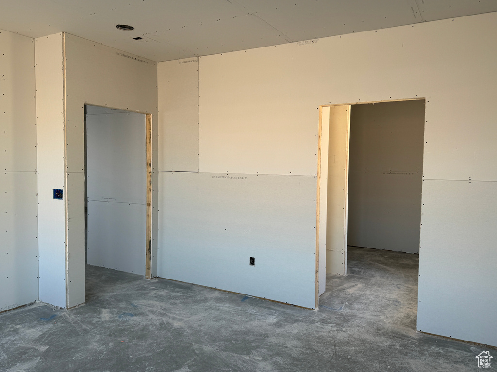Unfurnished bedroom featuring concrete floors