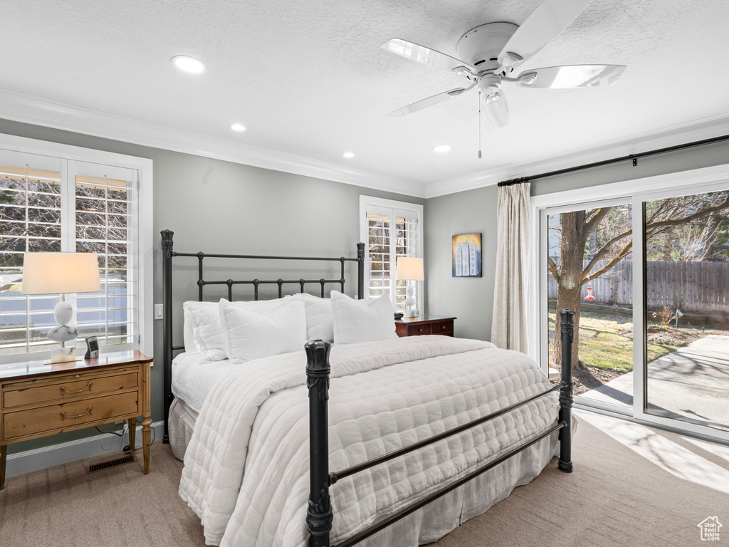 Carpeted bedroom with access to outside, ornamental molding, and ceiling fan