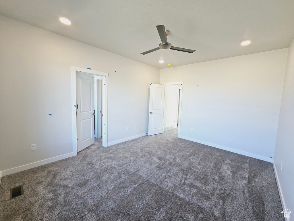 Spare room with carpet flooring and ceiling fan
