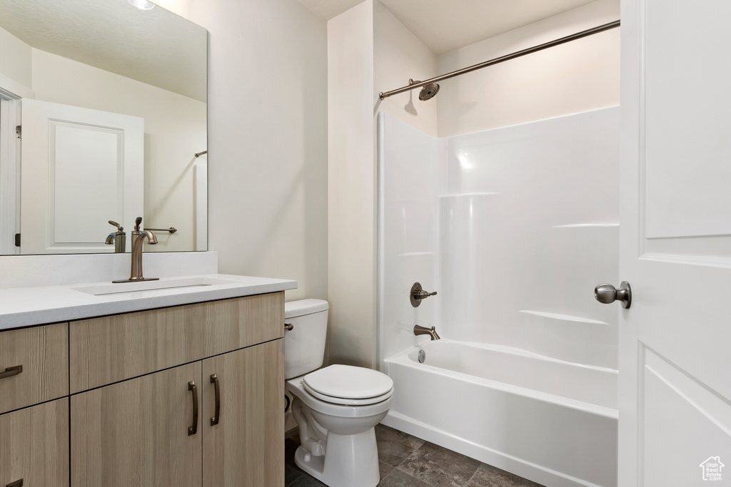 Full bathroom with vanity, toilet, tile flooring, and bathtub / shower combination