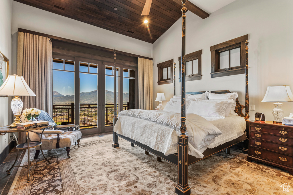 Bedroom with a mountain view, access to outside, high vaulted ceiling, wood ceiling, and dark hardwood / wood-style flooring