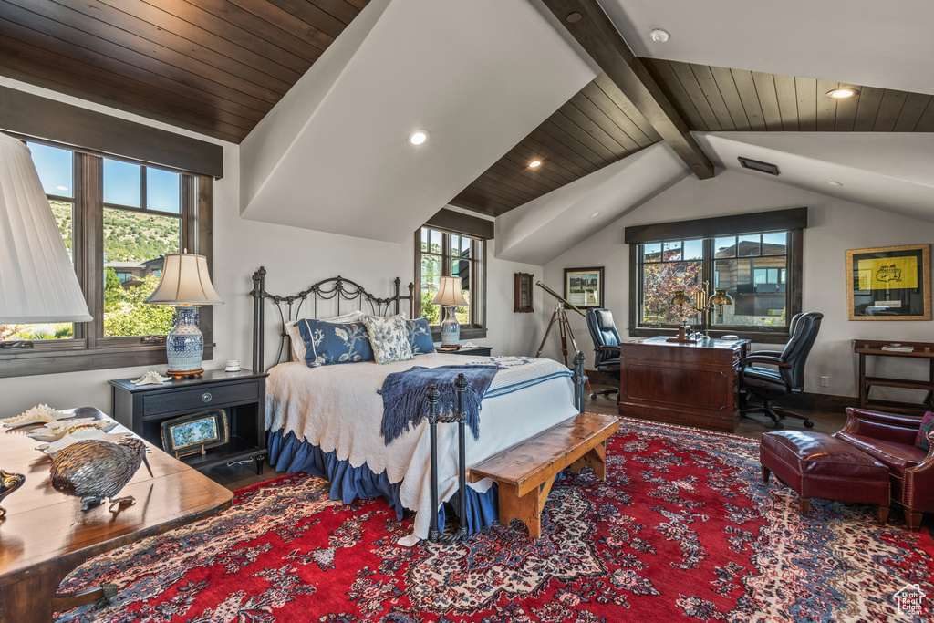 Bedroom with dark hardwood / wood-style flooring and lofted ceiling with beams