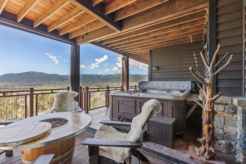 View of patio with a fire pit and a mountain view