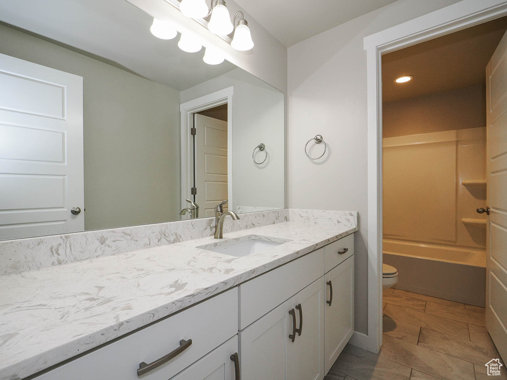 Full bathroom featuring vanity, toilet, bathing tub / shower combination, and tile floors
