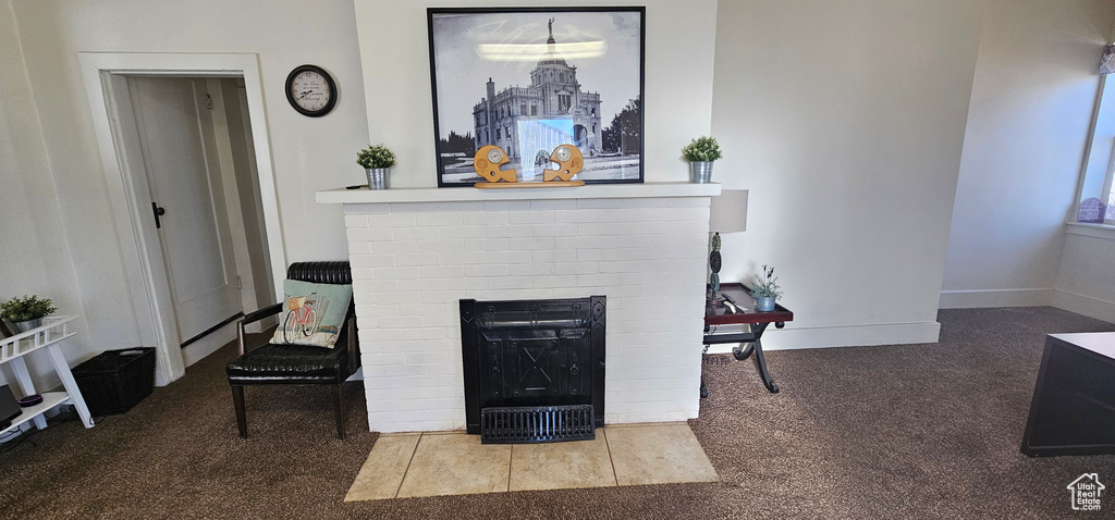 Sitting room with carpet floors and a brick fireplace