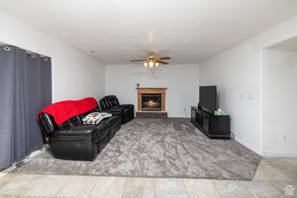 Tiled living room featuring ceiling fan