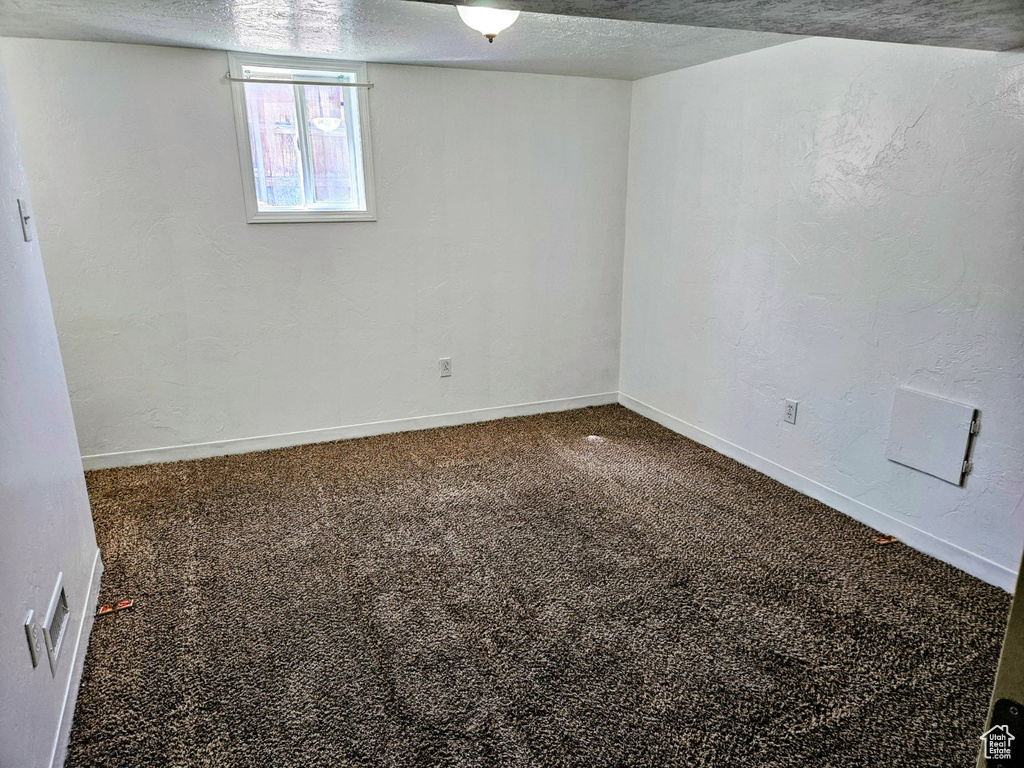 Interior space with a textured ceiling and carpet