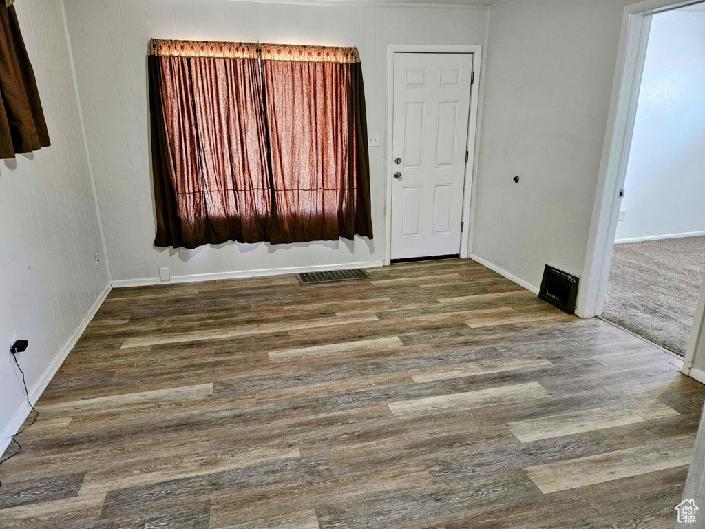 Spare room with dark hardwood / wood-style flooring