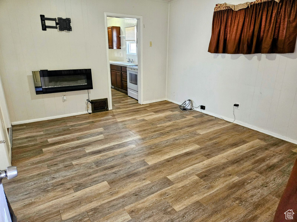 Unfurnished living room with dark hardwood / wood-style flooring and sink