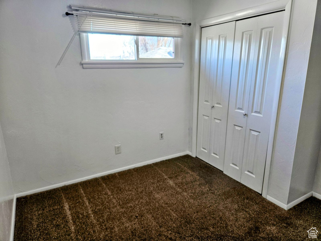 Unfurnished bedroom featuring carpet floors and a closet