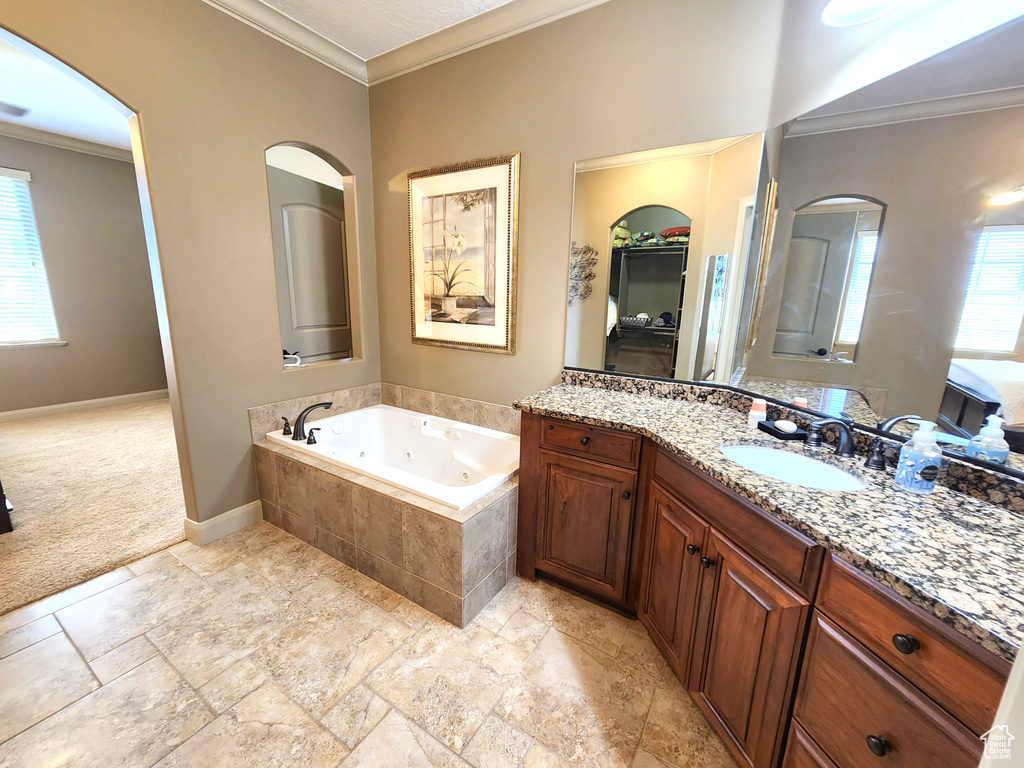 Bathroom with vanity, tile flooring, a healthy amount of sunlight, and crown molding