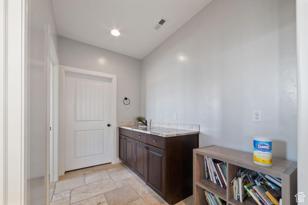 Bathroom with vanity, lofted ceiling, and tile floors