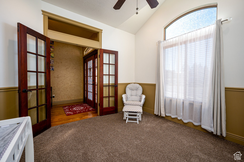 Unfurnished room with ceiling fan, french doors, dark colored carpet, and lofted ceiling