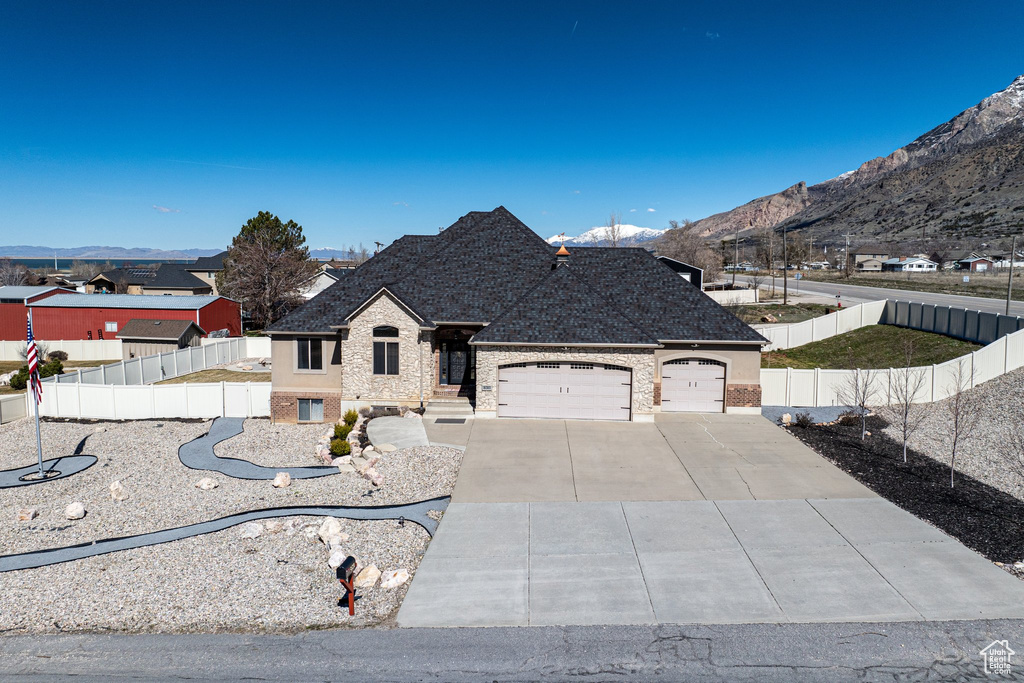 View of front of house with a garage and a mountain view