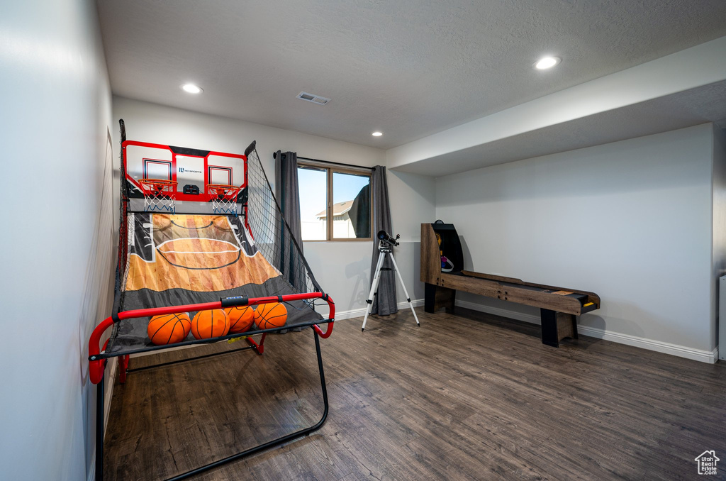 Bedroom with dark wood-type flooring and a textured ceiling