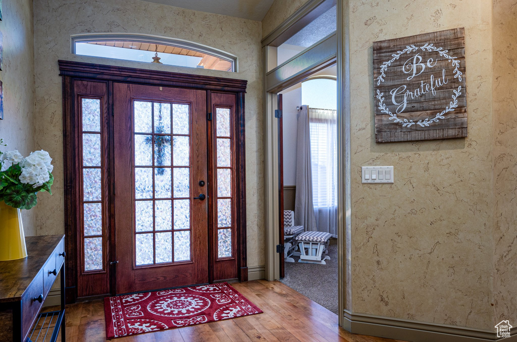 Entrance foyer with hardwood / wood-style floors