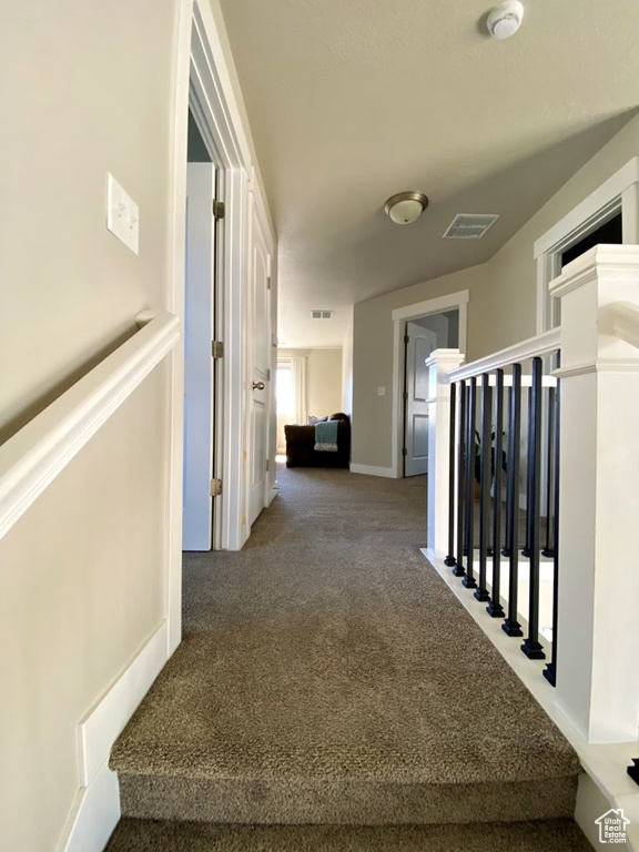 Hallway with dark carpet