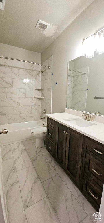 Full bathroom with vanity with extensive cabinet space, tiled shower / bath combo, and tile flooring