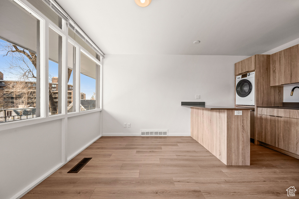 Kitchen featuring light hardwood / wood-style flooring and washer / clothes dryer