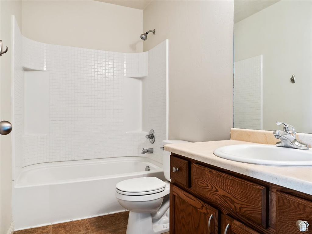 Full bathroom with vanity, toilet, tile flooring, and bathtub / shower combination
