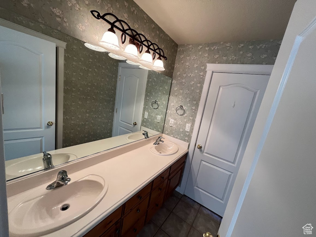 Bathroom with tile floors, dual sinks, and oversized vanity