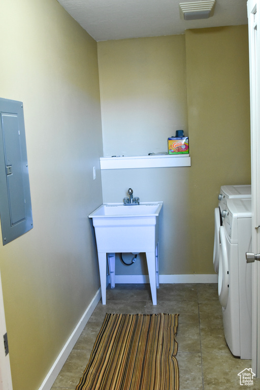Interior space featuring dark tile floors and washer and dryer