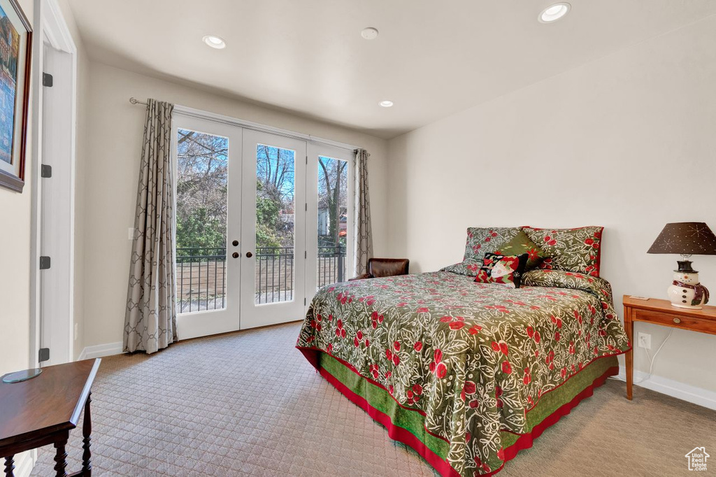 Bedroom featuring french doors, light carpet, and access to outside