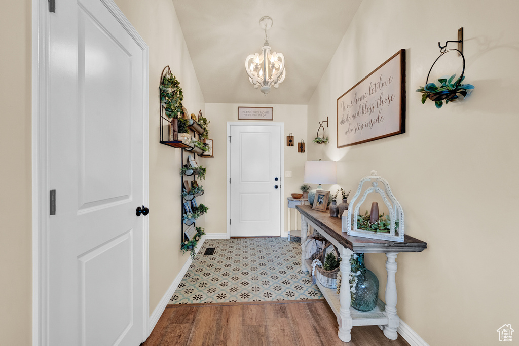 Entryway with a notable chandelier and hardwood / wood-style floors